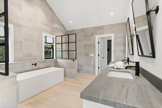 a spacious bedroom with a bed and a couch