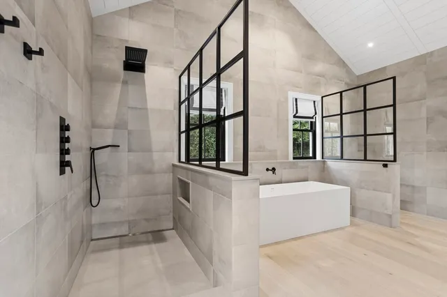 a bathroom with a bathtub and a shower