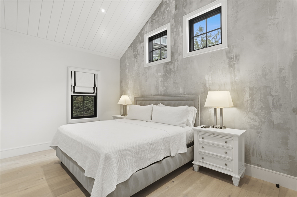 3 Old Mill Court Nantucket, MA 02554 - Photo 20 of 42 a bedroom with a bed and a lamp on the dresser