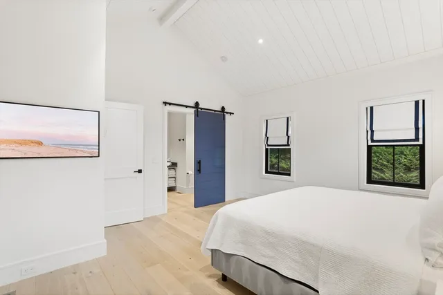 a bedroom with a large bed and a window