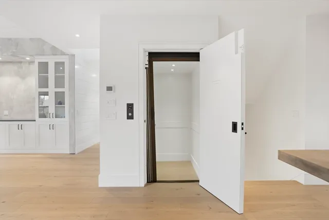 an entryway with wooden floor and windows