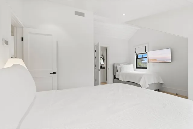 a bedroom with a bed and a lamp