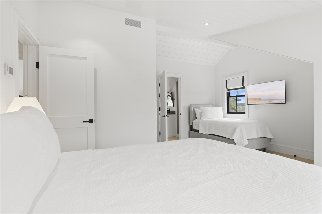 3 Old Mill Court Nantucket, MA 02554 - Photo 26 of 42 a bedroom with a bed and a lamp