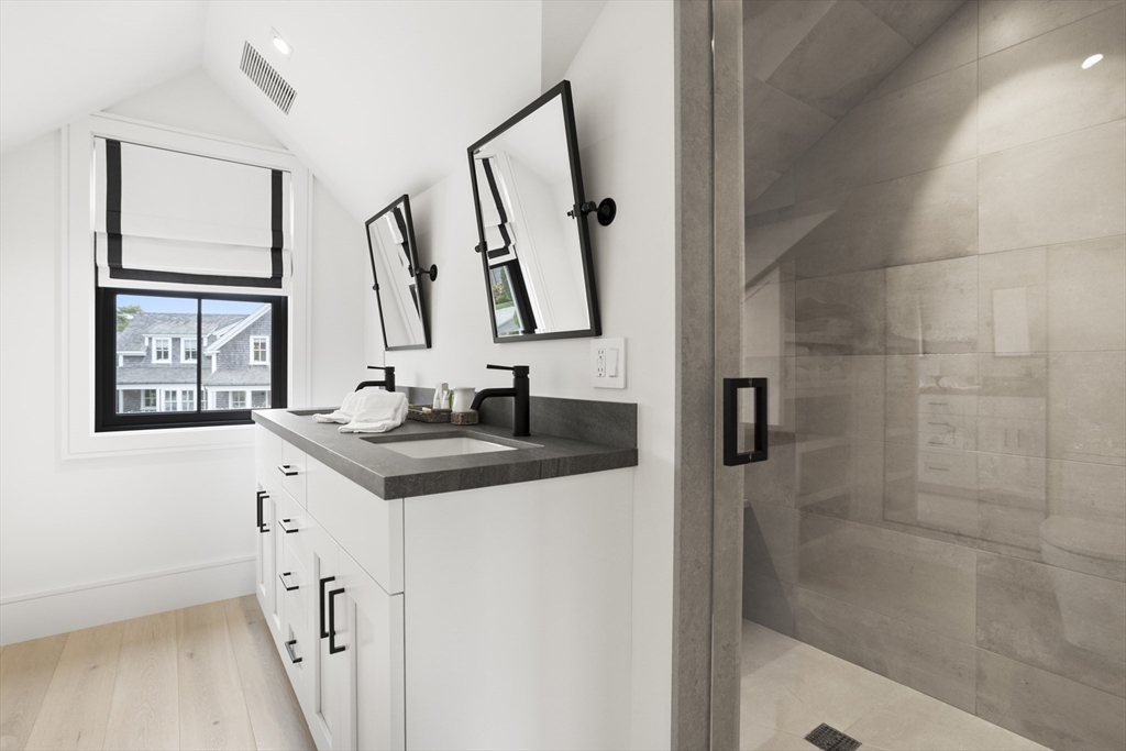 3 Old Mill Court Nantucket, MA 02554 - Photo 27 of 42 a bathroom with a granite countertop sink a mirror and a shower