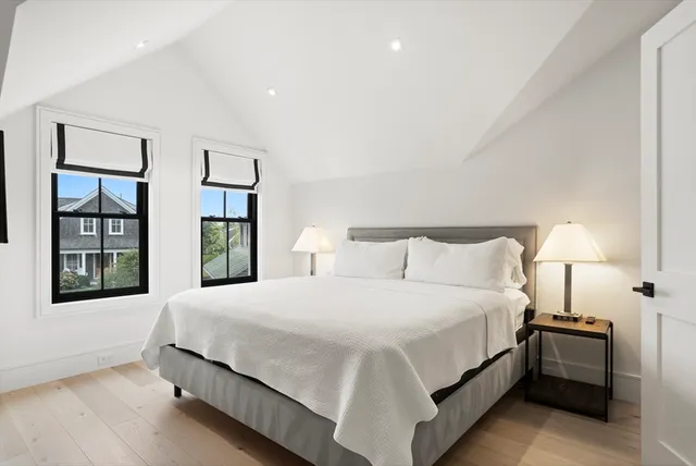 a bedroom with a large bed and a night stand