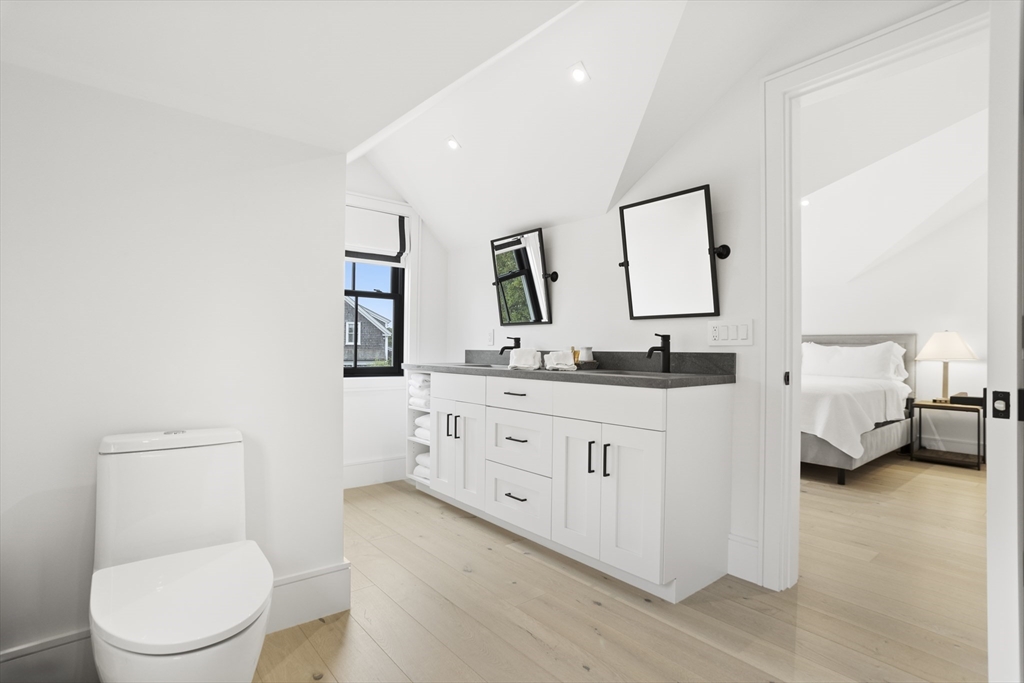 3 Old Mill Court Nantucket, MA 02554 - Photo 30 of 42 a bathroom with a granite countertop sink mirror vanity and toilet