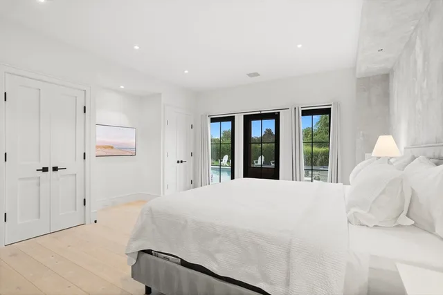 a bedroom with a large bed and a window