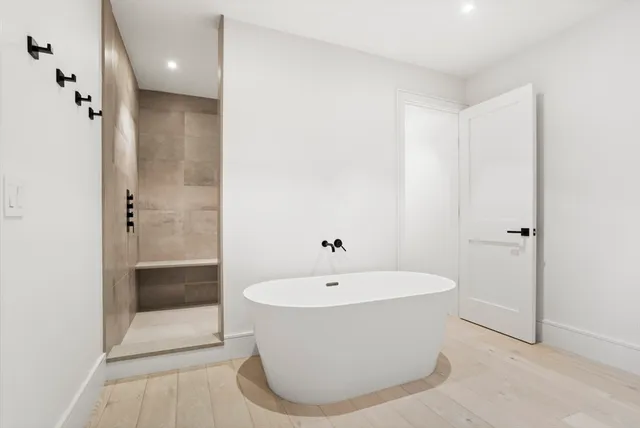 a bathroom with a bathtub and shower