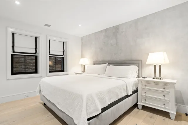 a bedroom with a bed and a night stand