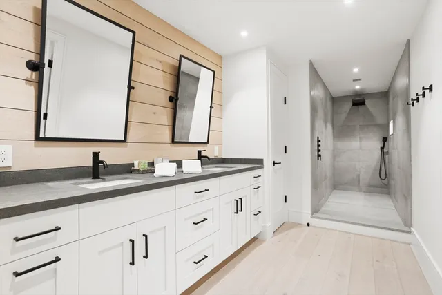 a bathroom with a granite countertop sink mirror and double