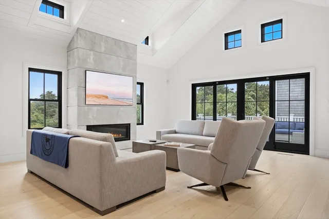 a living room with furniture and a floor to ceiling window