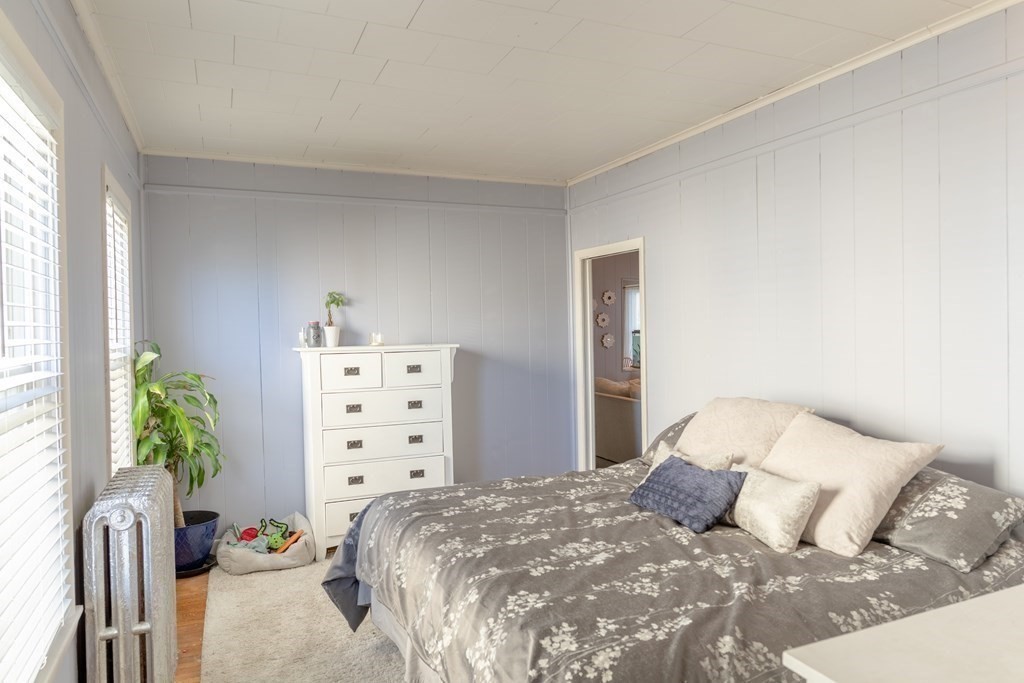 195 Barnaby Street Fall River, MA 02720 - Photo 12 of 25 a bedroom with a bed and a potted plant