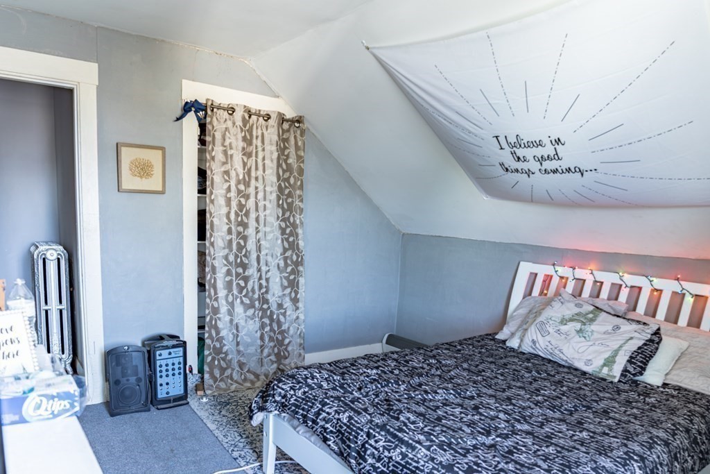 195 Barnaby Street Fall River, MA 02720 - Photo 17 of 25 a bedroom with a bed and a chandelier