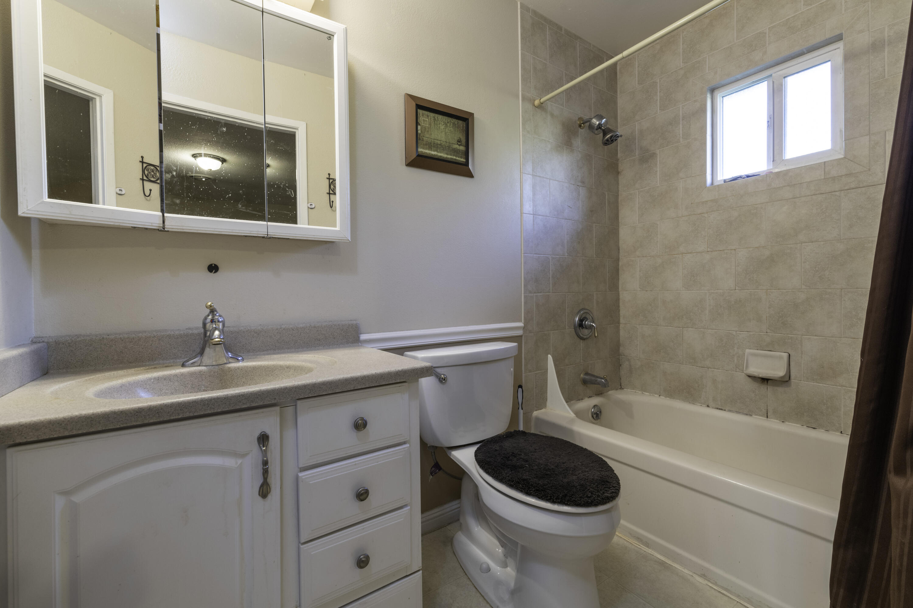 2816 Squire Avenue Redding, CA 96002 - Photo 11 of 13 a bathroom with a granite countertop sink toilet and shower