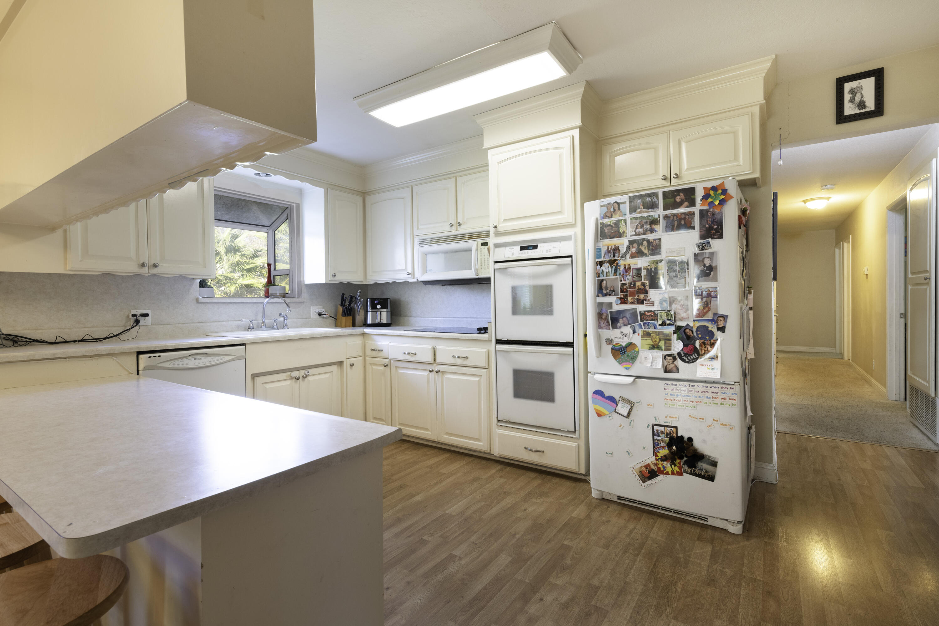 2816 Squire Avenue Redding, CA 96002 - Photo 3 of 13 a kitchen with white cabinets and white appliances