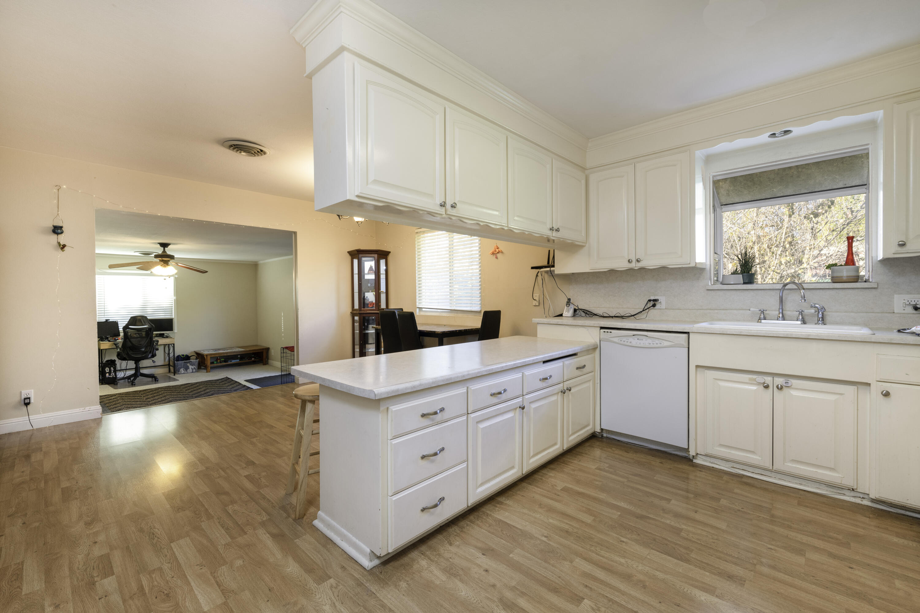 2816 Squire Avenue Redding, CA 96002 - Photo 4 of 13 a kitchen with sink cabinets and wooden floor