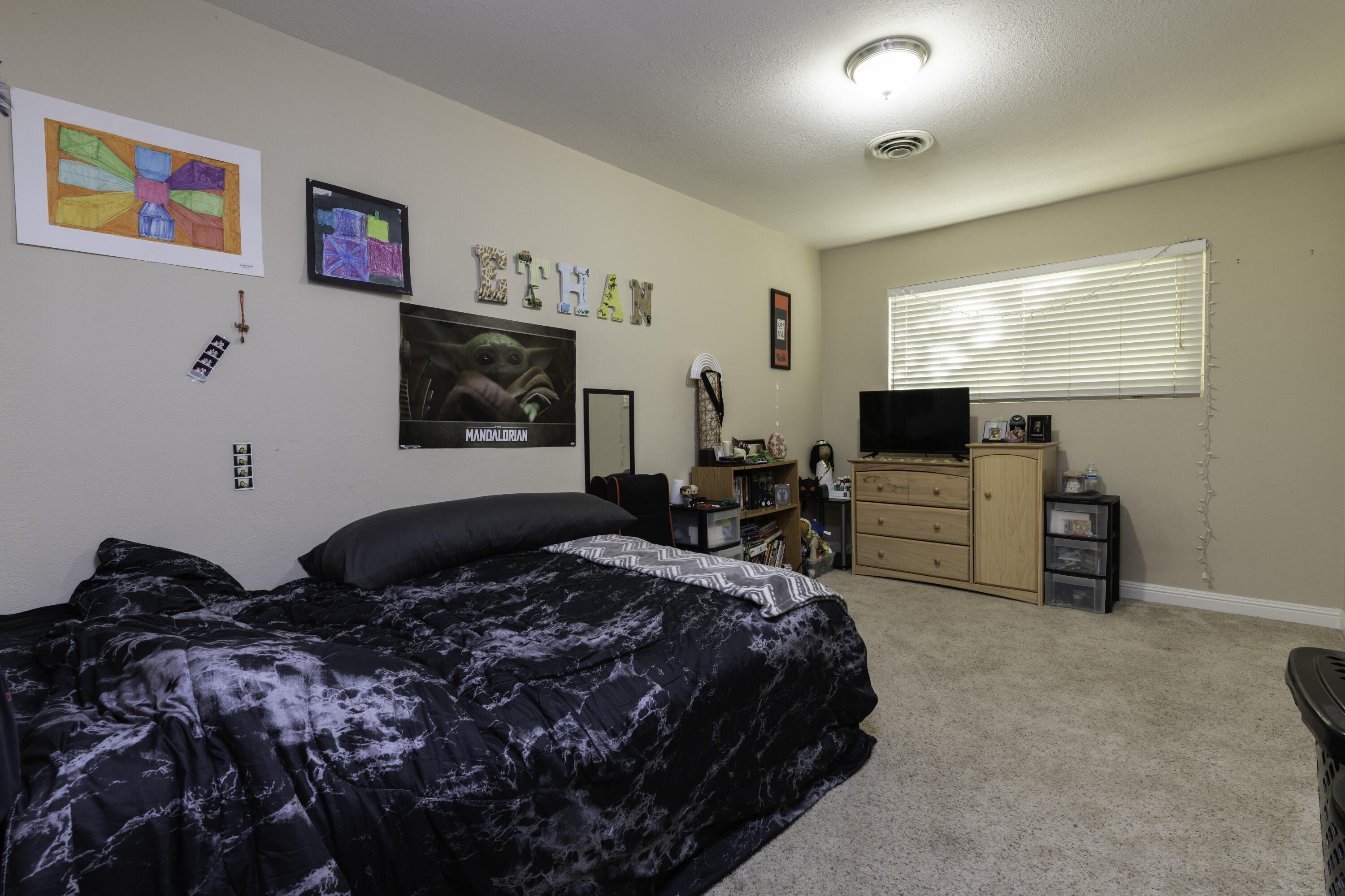 2816 Squire Avenue Redding, CA 96002 - Photo 7 of 13 a bedroom with a bed and a flat screen tv