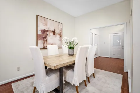 a view of a dining room with furniture and a potted plant