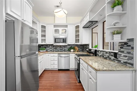 a kitchen with a sink stove and refrigerator