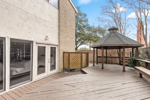 a view of a dinning table and chairs in patio of the house