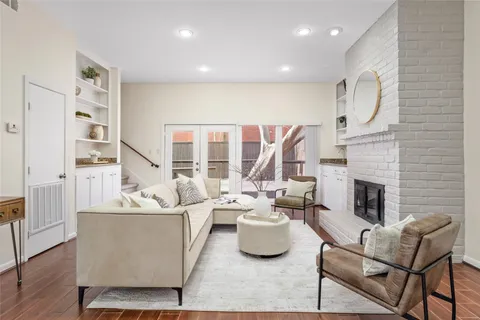a living room with furniture fireplace and a large window