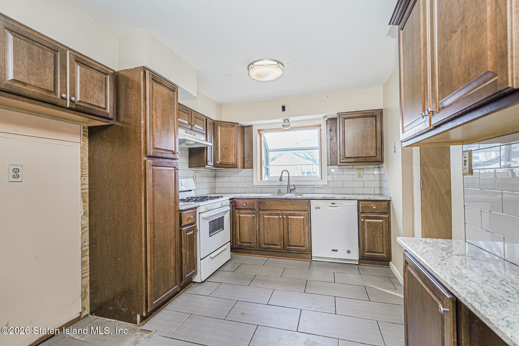 1 Fillat Street Staten Island, NY 10314 - Photo 11 of 39 a kitchen with stainless steel appliances granite countertop a refrigerator and stove top oven