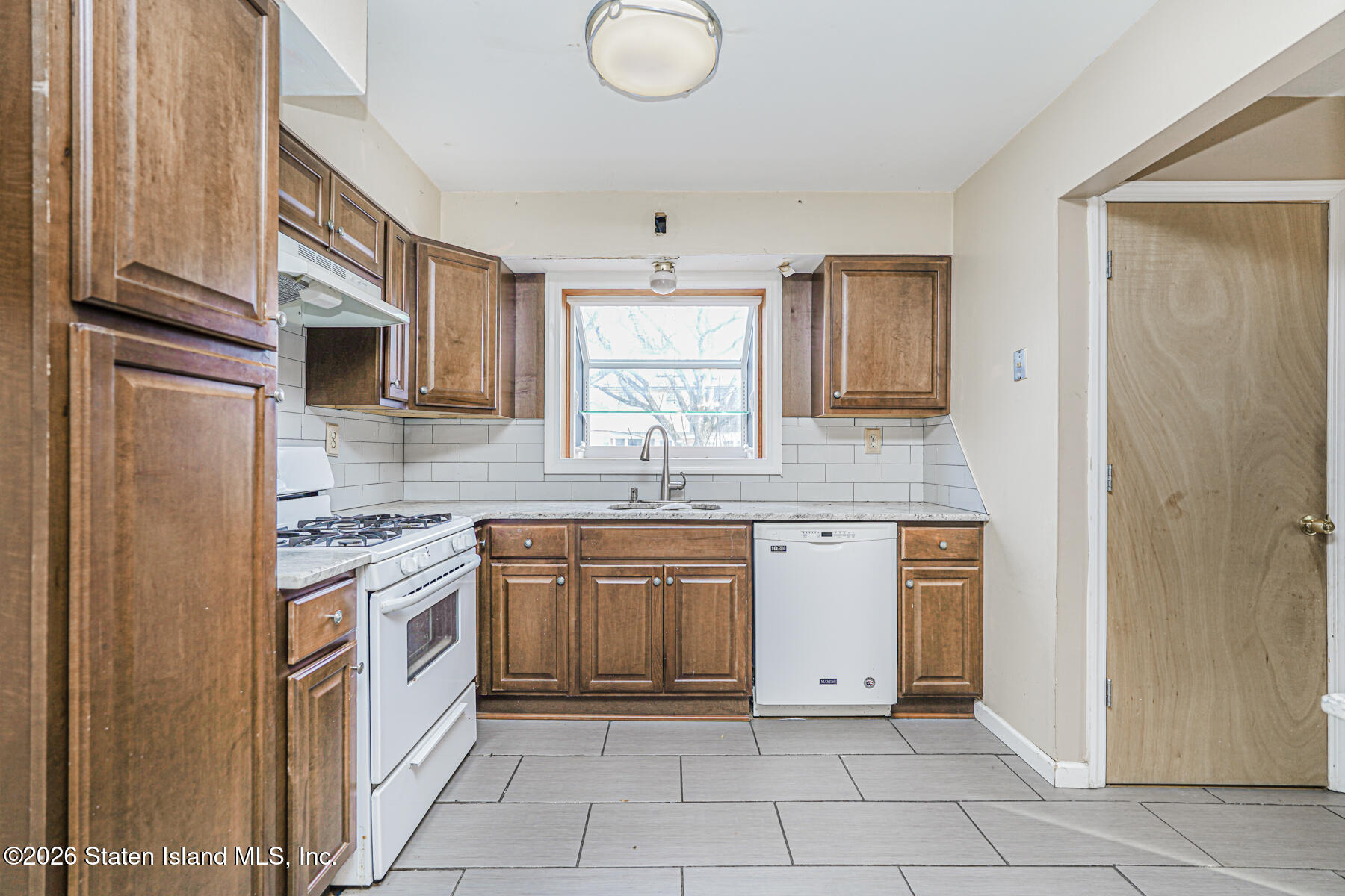 1 Fillat Street Staten Island, NY 10314 - Photo 12 of 39 a kitchen with stainless steel appliances granite countertop a stove a sink and a refrigerator