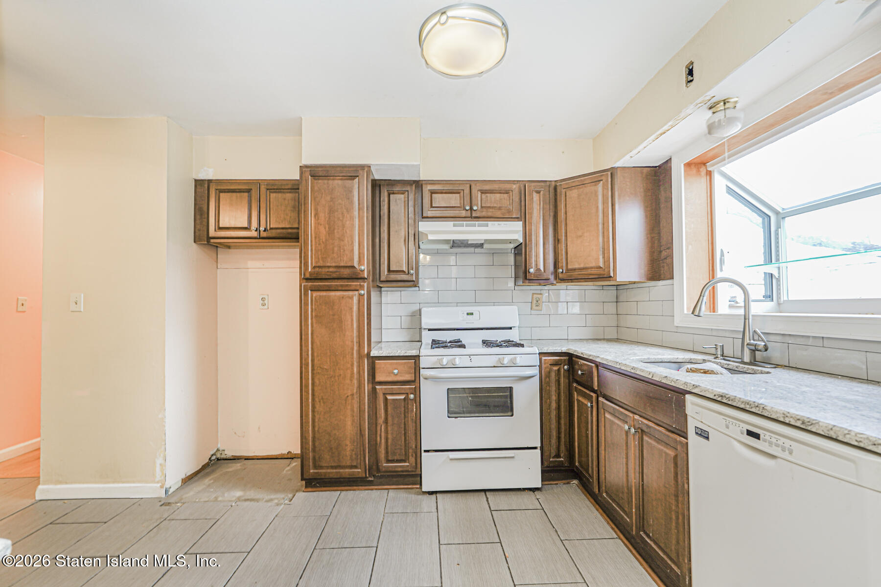 1 Fillat Street Staten Island, NY 10314 - Photo 13 of 39 a kitchen with stainless steel appliances granite countertop a stove a sink and a refrigerator