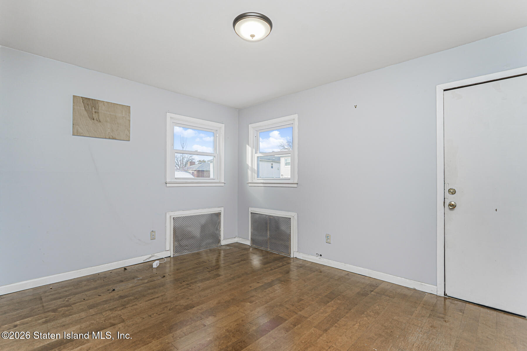 1 Fillat Street Staten Island, NY 10314 - Photo 16 of 39 an empty room with wooden floor and window