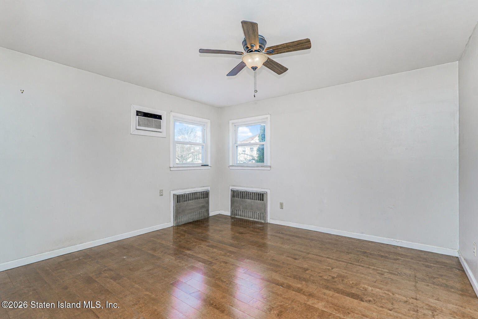 1 Fillat Street Staten Island, NY 10314 - Photo 18 of 39 an empty room with wooden floor closet and windows