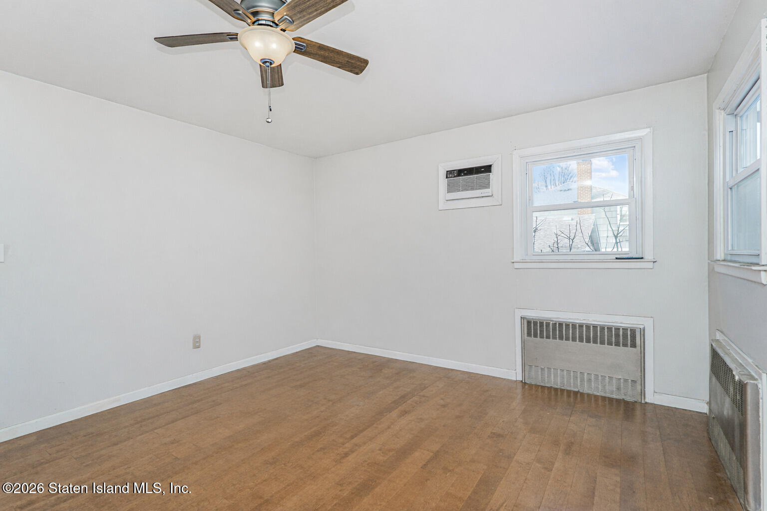 1 Fillat Street Staten Island, NY 10314 - Photo 19 of 39 an empty room with a window and a ceiling fan