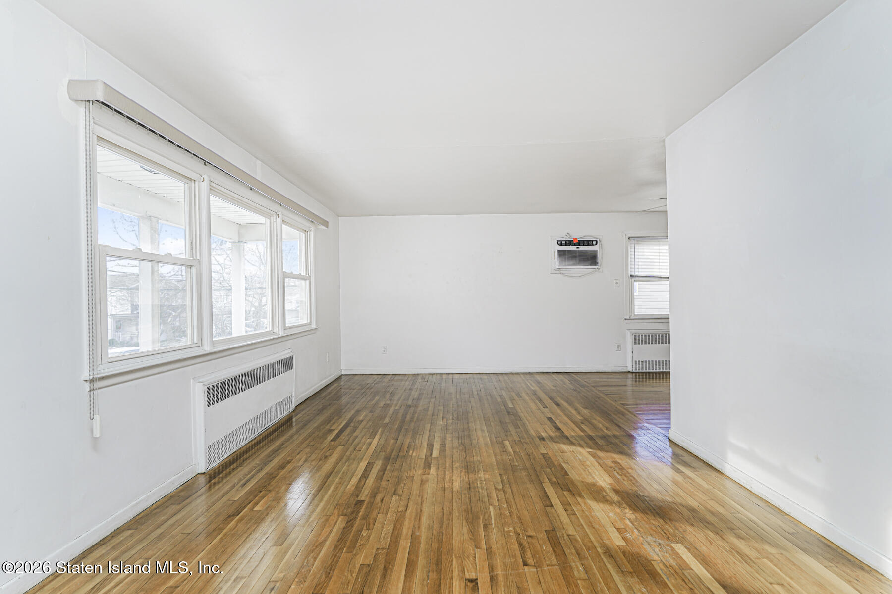 1 Fillat Street Staten Island, NY 10314 - Photo 26 of 39 an empty room with wooden floor and windows