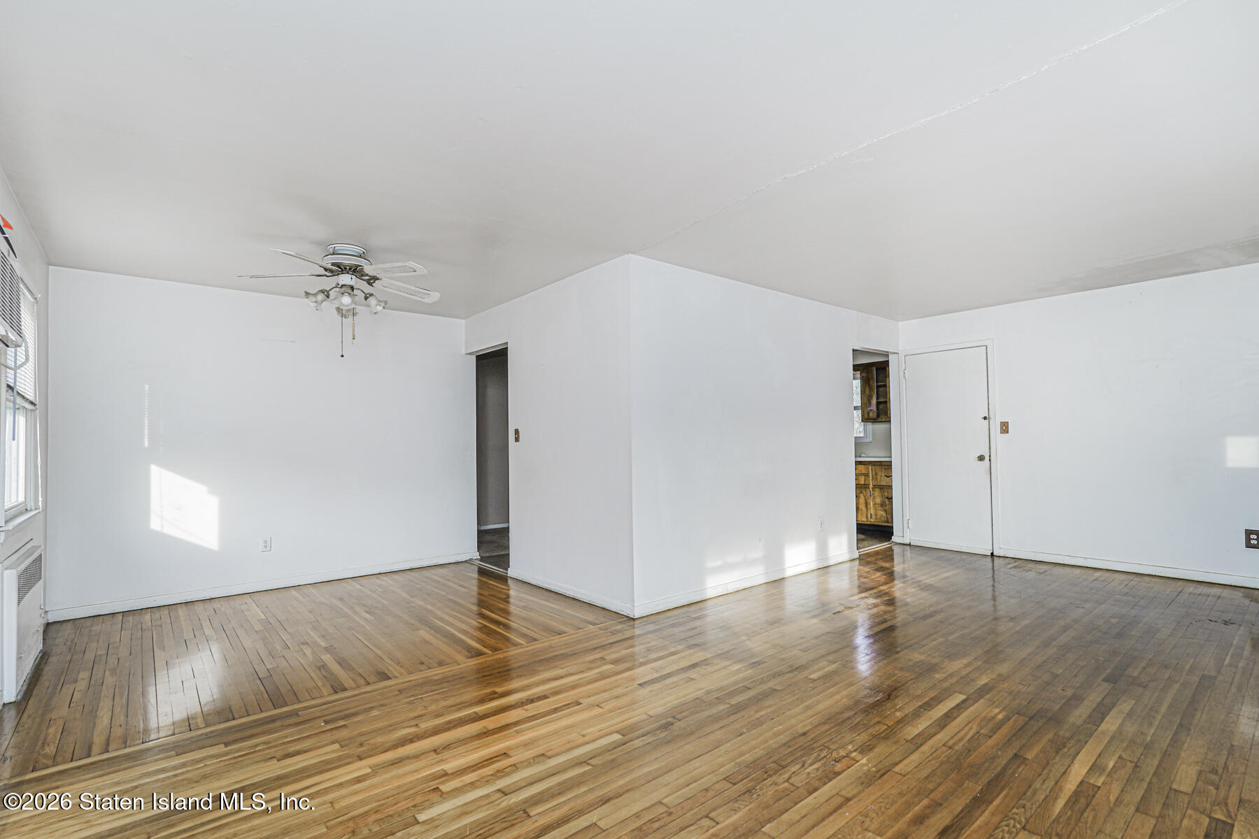 1 Fillat Street Staten Island, NY 10314 - Photo 27 of 39 an empty room with wooden floor cabinet and windows