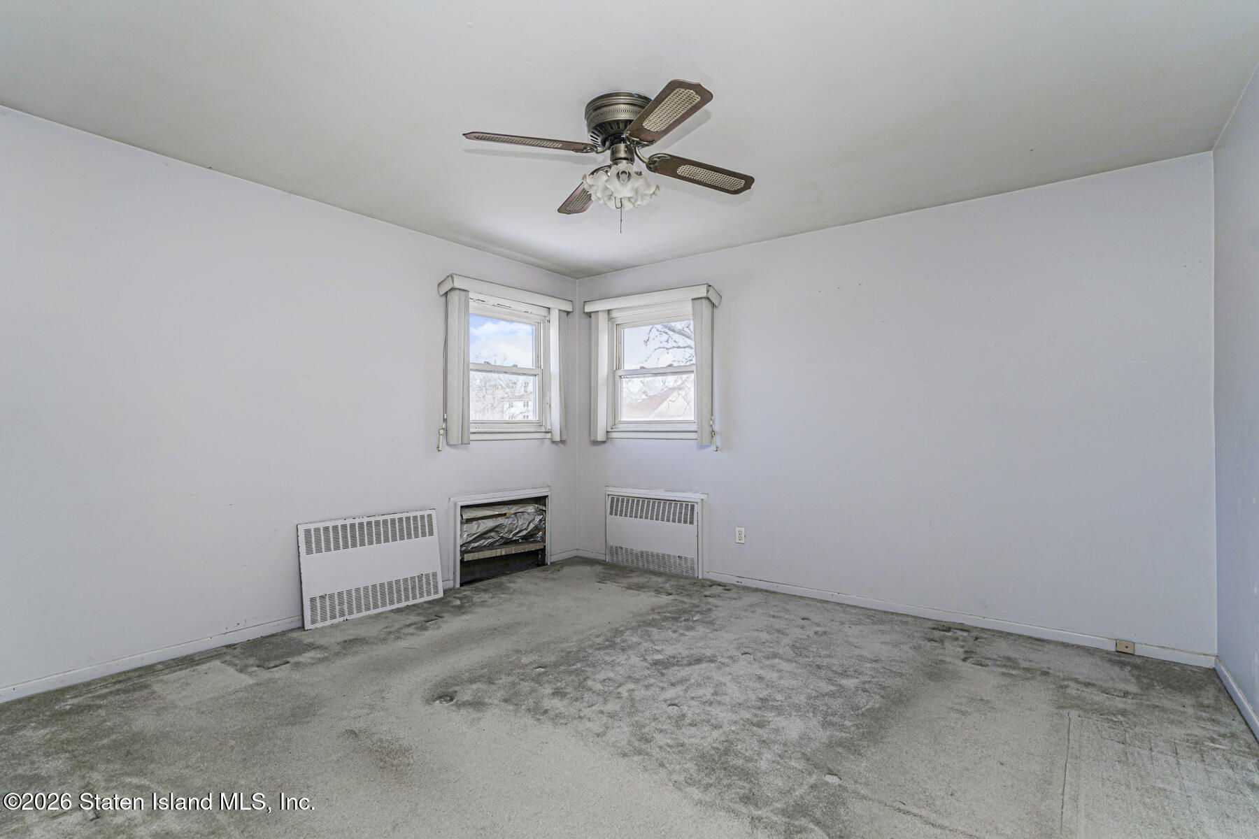 1 Fillat Street Staten Island, NY 10314 - Photo 34 of 39 a view of an empty room with a ceiling fan and window