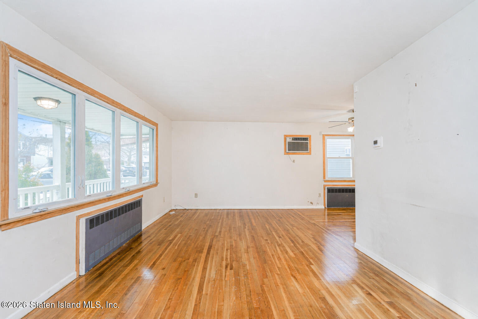 1 Fillat Street Staten Island, NY 10314 - Photo 6 of 39 a view of empty room with wooden floor and fan