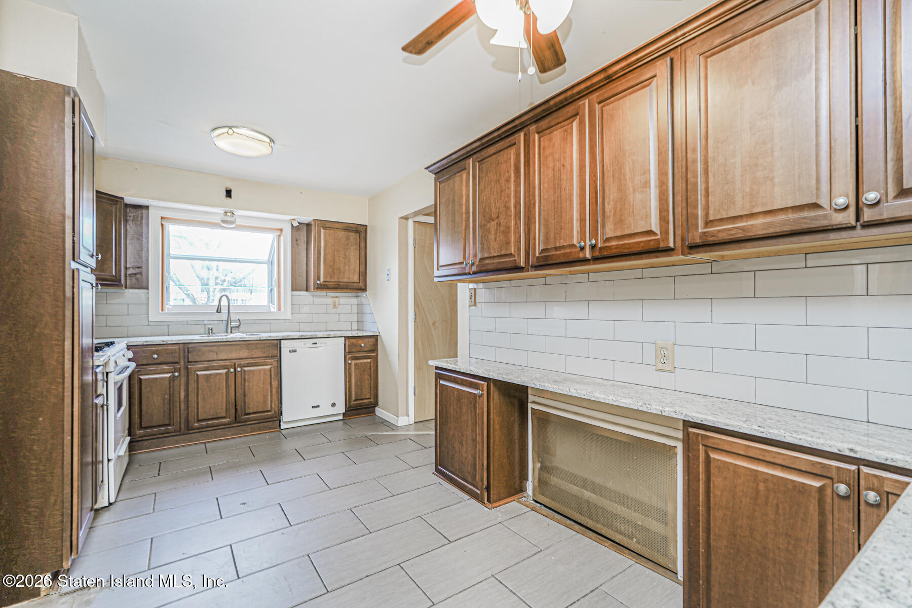 1 Fillat Street Staten Island, NY 10314 - Photo 10 of 39 a kitchen with a stove a sink and a refrigerator