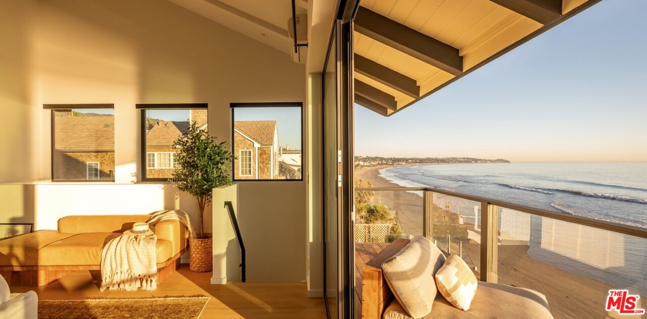 31376 Broad Beach Road Malibu, CA 90265 - Photo 26 of 32 a view of a balcony with furniture and floor to ceiling window