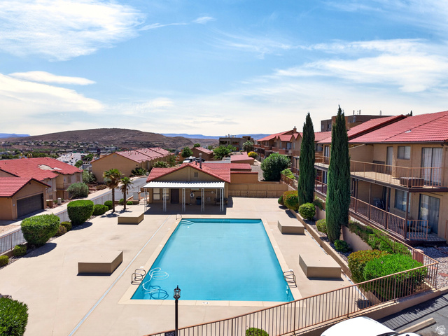 161 West 950 South, Unit Q1 St. George, UT 84770 - Photo 2 of 37 Community pool with a patio area, a residential view, and a mountain view