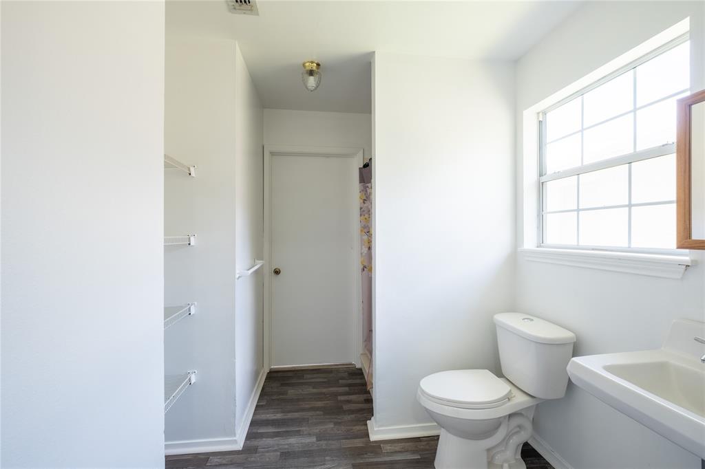 3126 Colgate Avenue Tyler, TX 75701 - Photo 23 of 33 a bathroom with a toilet and a window