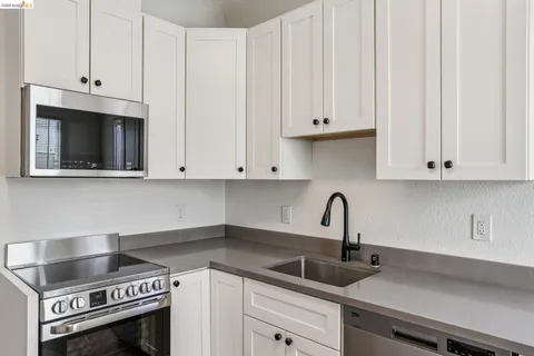 a bathroom with a shower sink vanity and mirror