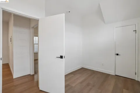 a view of a room with wooden floor and a window