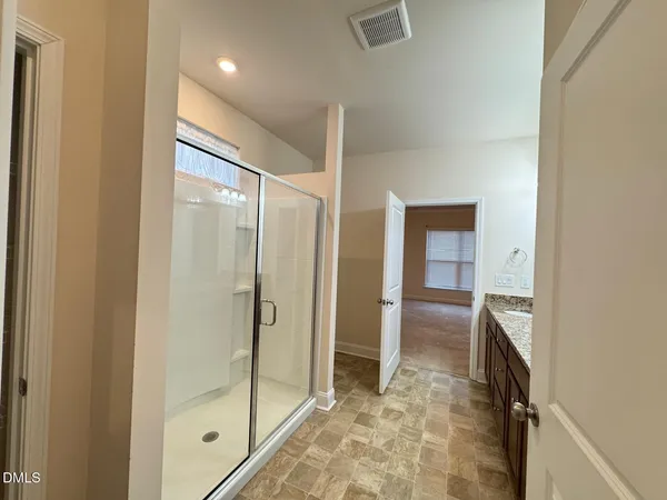 a bathroom with a shower and a sink