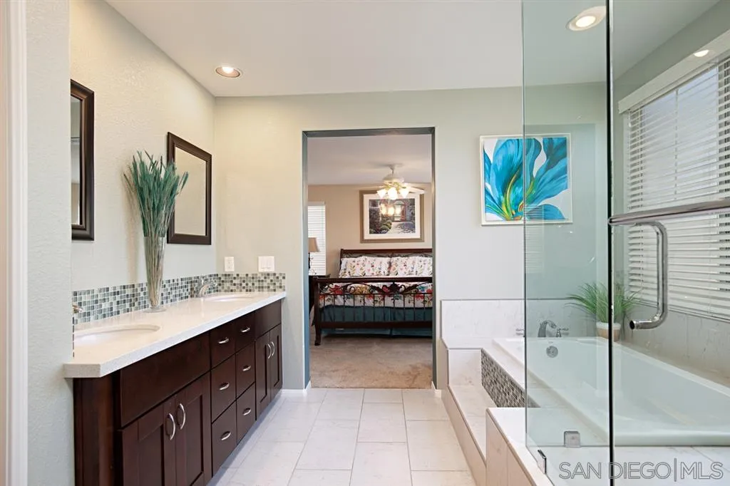 2170 Boulders Road Alpine, CA 91901 - Photo 16 of 24 a bathroom with a tub sink and mirror