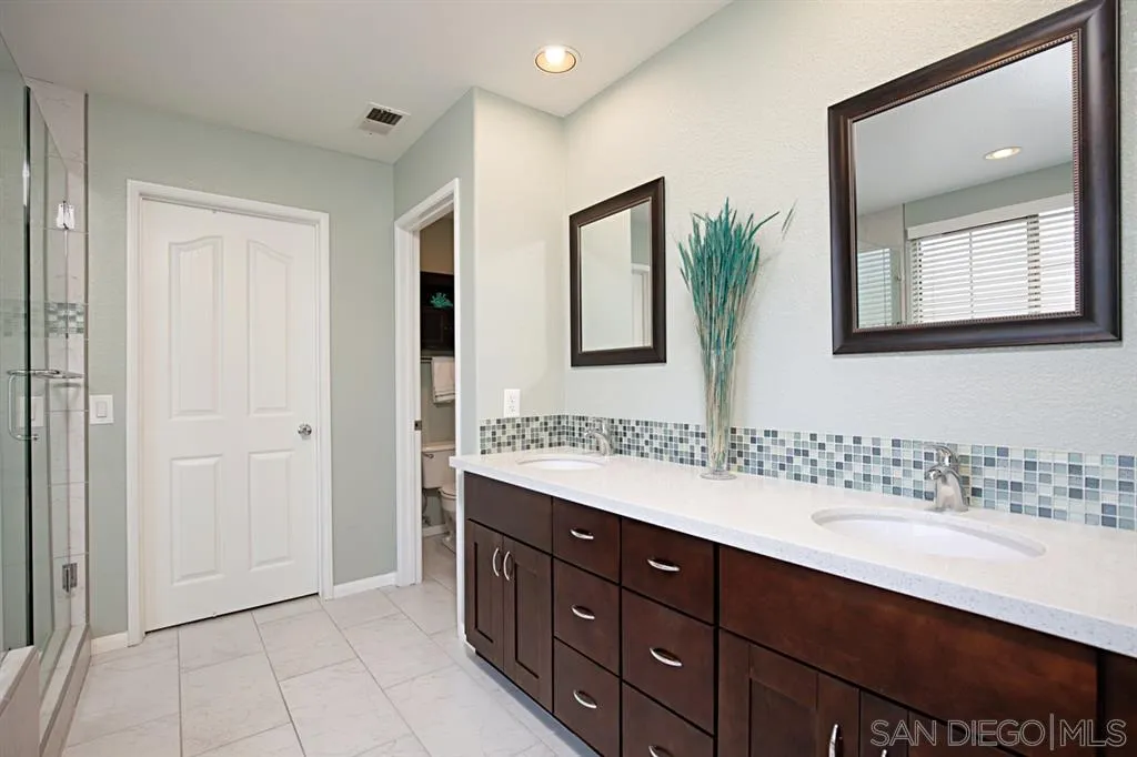 2170 Boulders Road Alpine, CA 91901 - Photo 17 of 24 a bathroom with a double vanity sink and a mirror