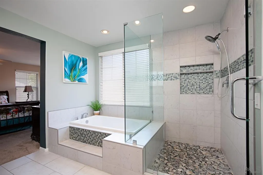 2170 Boulders Road Alpine, CA 91901 - Photo 18 of 24 a bathroom with a granite countertop sink a toilet and shower