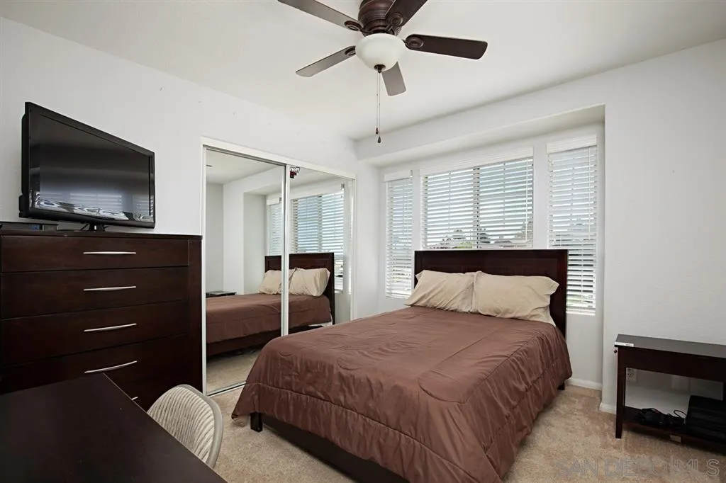 2170 Boulders Road Alpine, CA 91901 - Photo 19 of 24 a bedroom with a bed and a flat screen tv