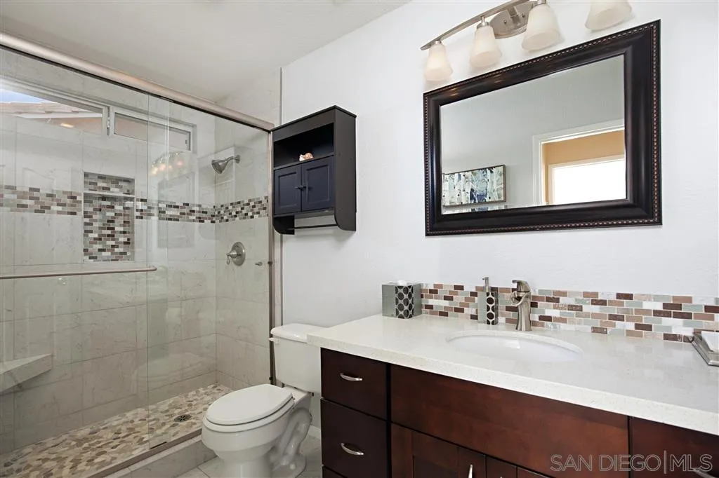 2170 Boulders Road Alpine, CA 91901 - Photo 21 of 24 a bathroom with a toilet sink and mirror