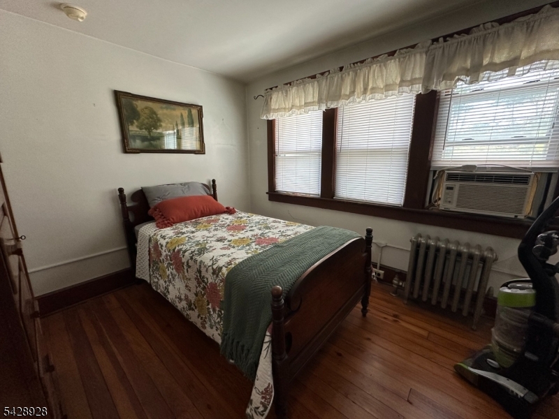 13 Cemetery Road Great Meadows, NJ 07838 - Photo 13 of 20 a bedroom with a bed and a flat tv screen on the dresser