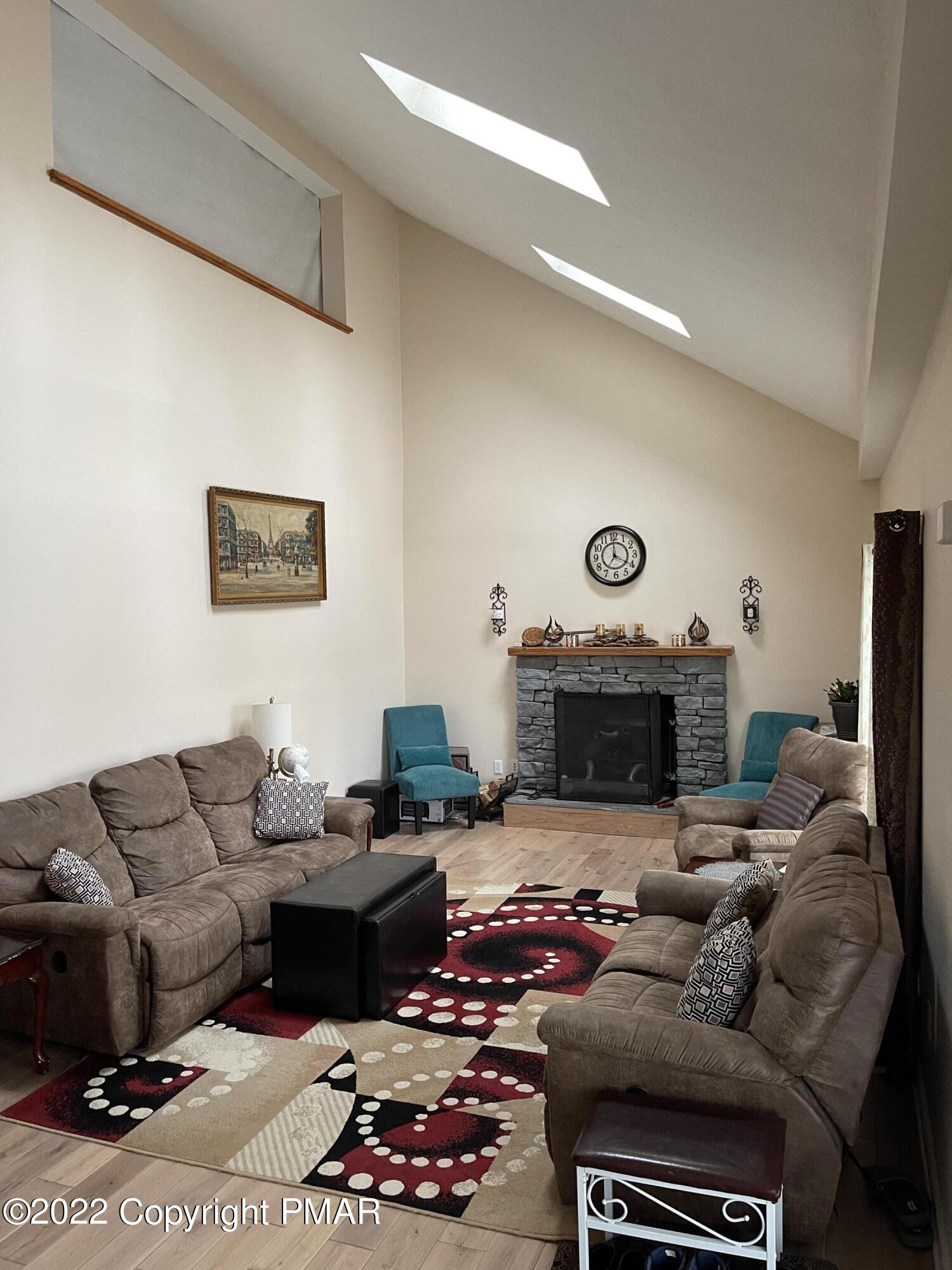 5665 Decker Road Bushkill, PA 18324 - Photo 11 of 32 a living room with furniture fireplace and a fireplace