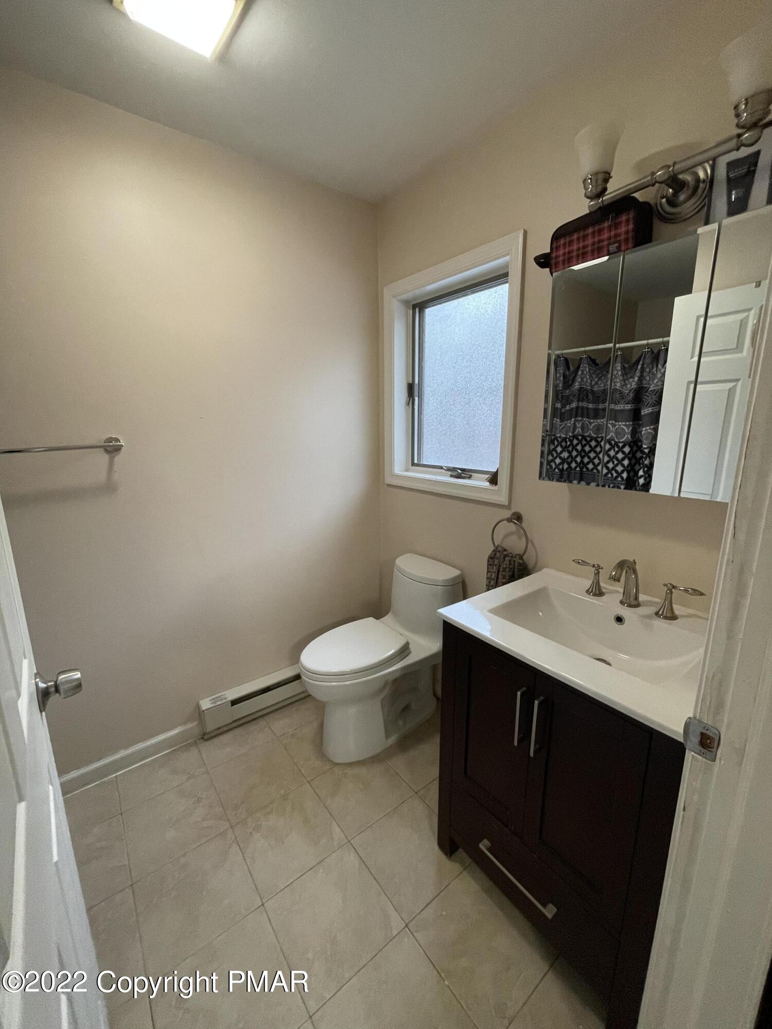 5665 Decker Road Bushkill, PA 18324 - Photo 19 of 32 a bathroom with a sink toilet and vanity
